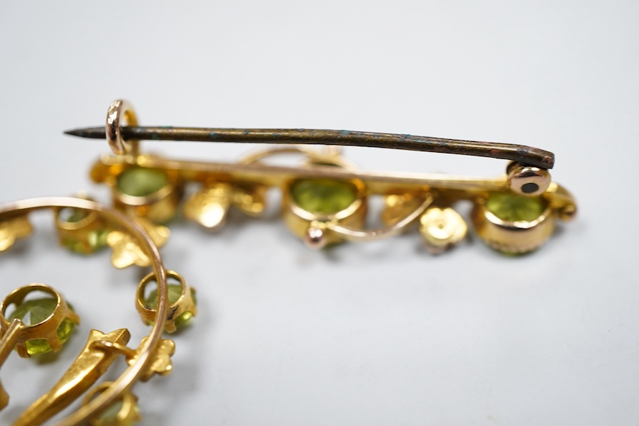 Two Edwardian peridot and seed pearl jewels, early 20th century, comprising: a bar brooch and a pendant, each of foliate design, set with circular-cut peridots and seed pearls, mounted in gold, brooch length 3.5cm, maker